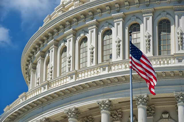 The downgrade causes a stir, Dalio clashes with the White House.